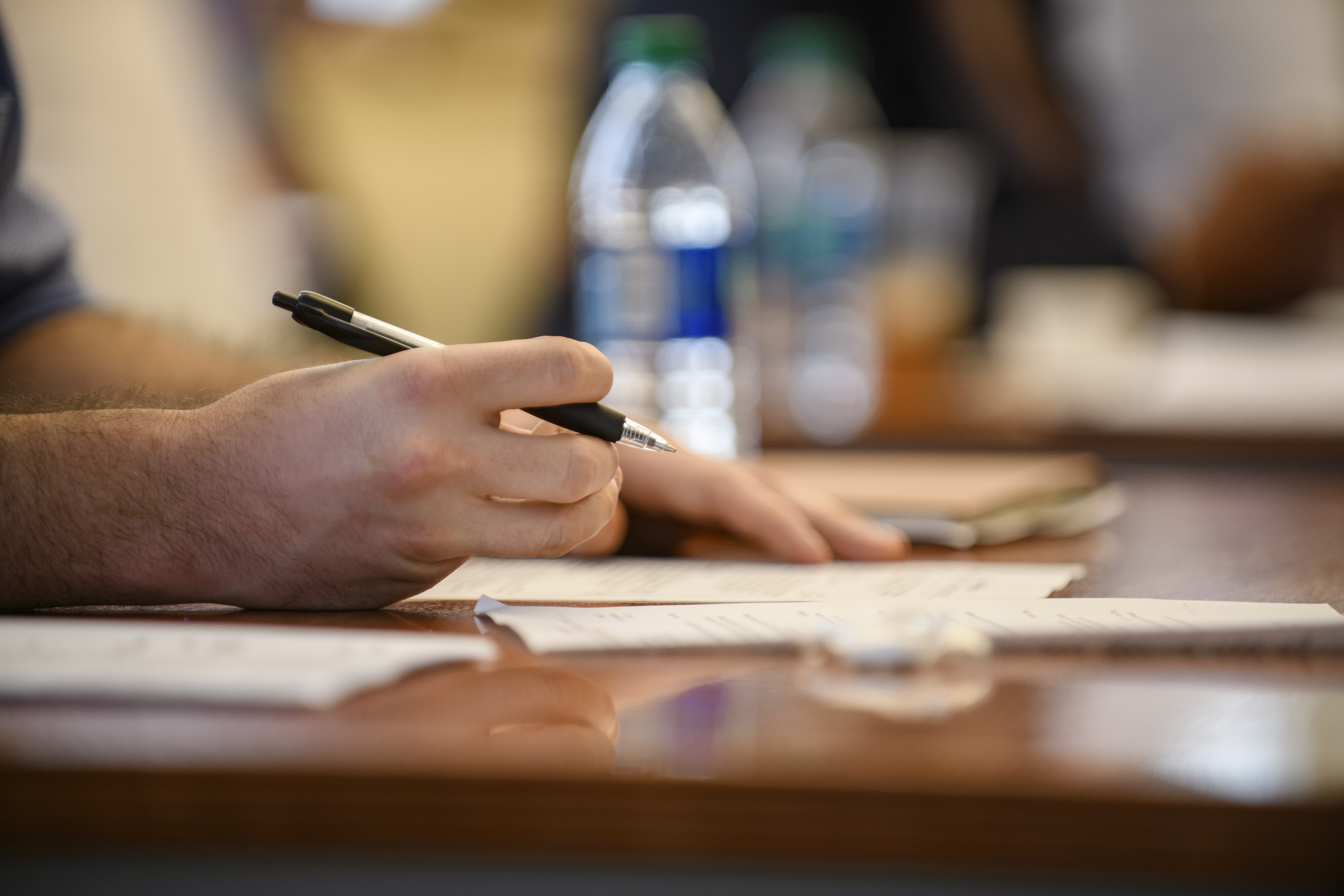 Hand writing a cover letter for organization.