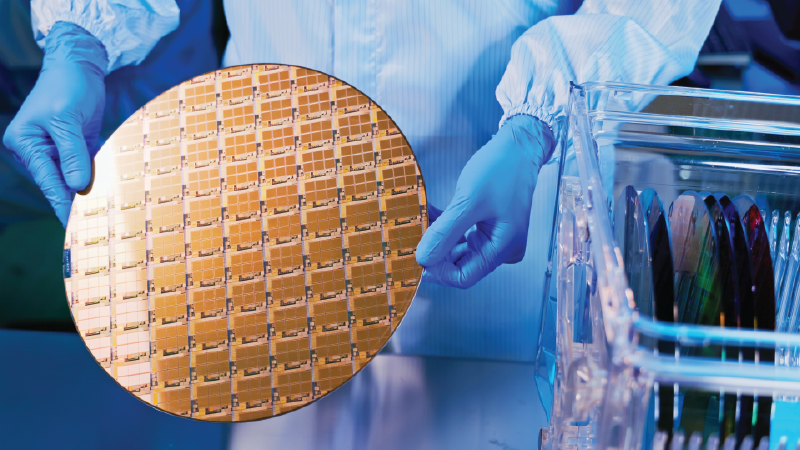 Semiconductor technician holding a wafer