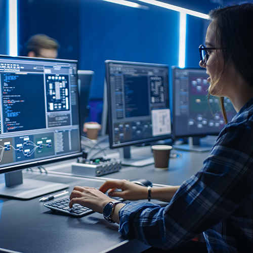woman working on coding at a computer