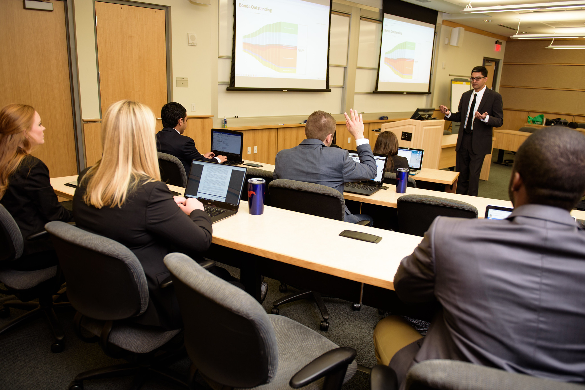 Muku teaches finance to class