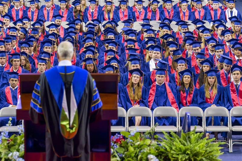 Dean Myers - on stage - addresses students in the audience