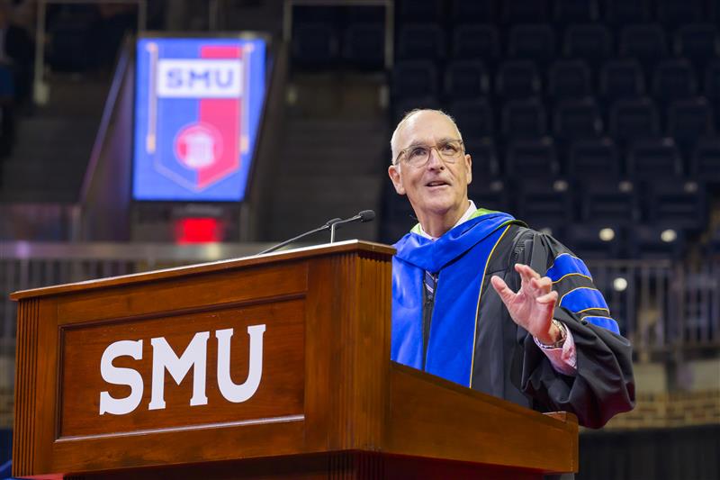 Dean Myers - on stage - addresses students in the audience