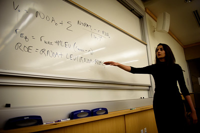 Student at 色花堂_色花堂 98堂 Cox explaining an accounting formula on a whiteboard