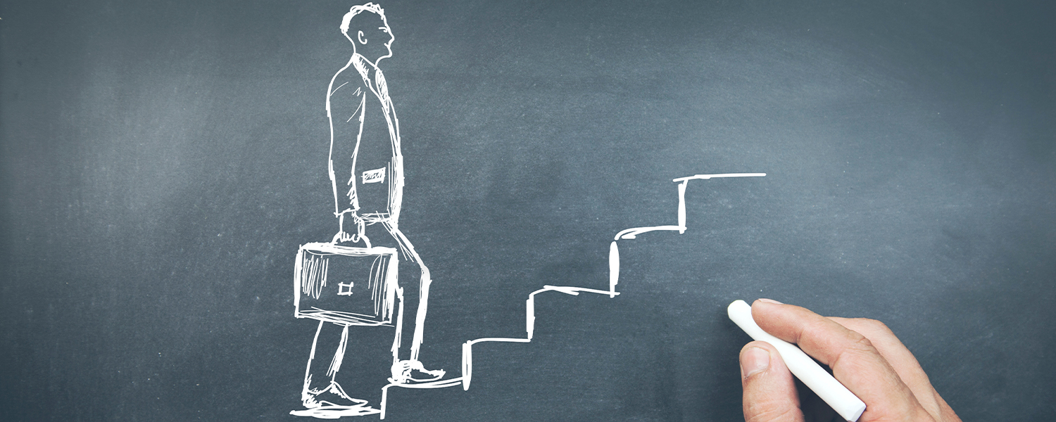 A chalk drawing of a businessman climbing steps