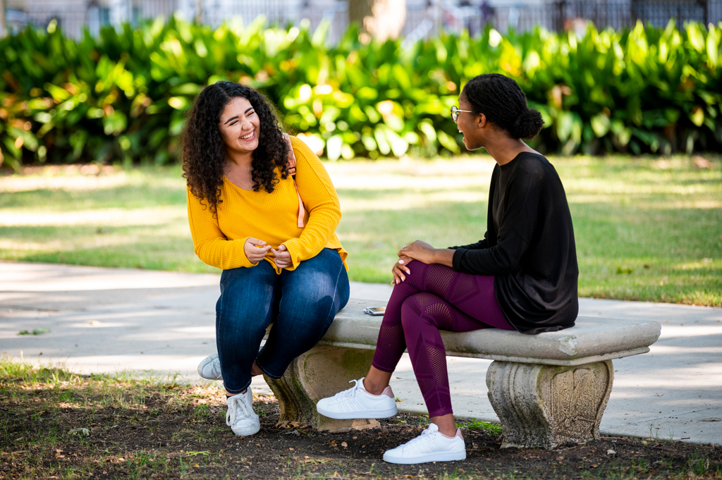two students sitting outside