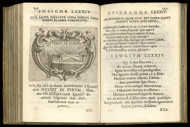 An open Latin book with an engraving of a mirror reflecting light from the sun on the left page.