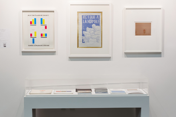 three framed colorful prints and table