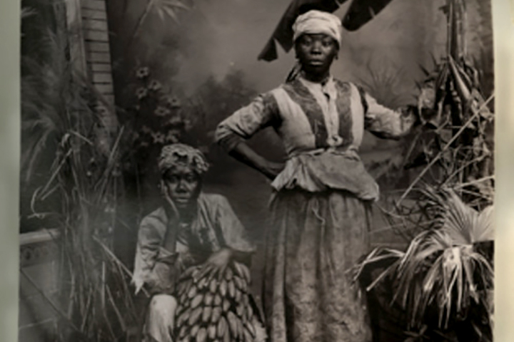 black and white photograph of two women & bananas