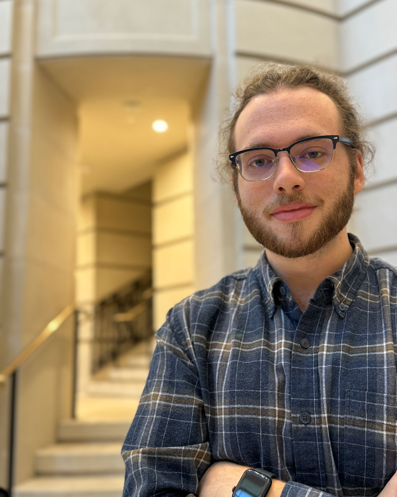 Music composition student Max Whittaker poses in an atrium