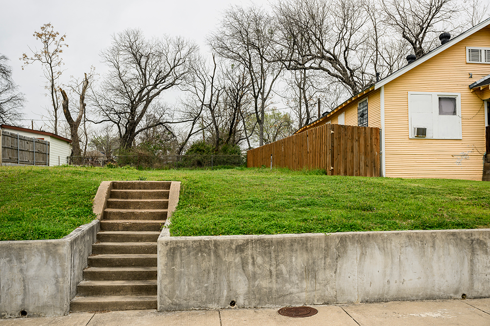 Steps lead to an empty lot where a home once stood