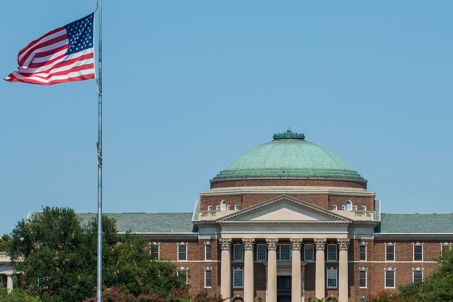 U.S. flag with Dallas Hall in the background