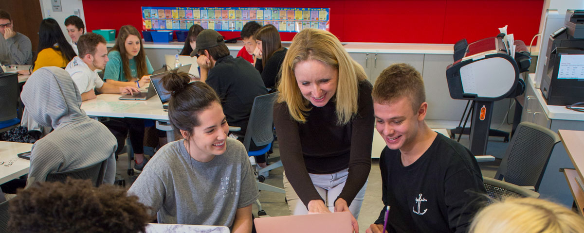 Simmons professor Abigail Pruitt works with students in the Design Lab