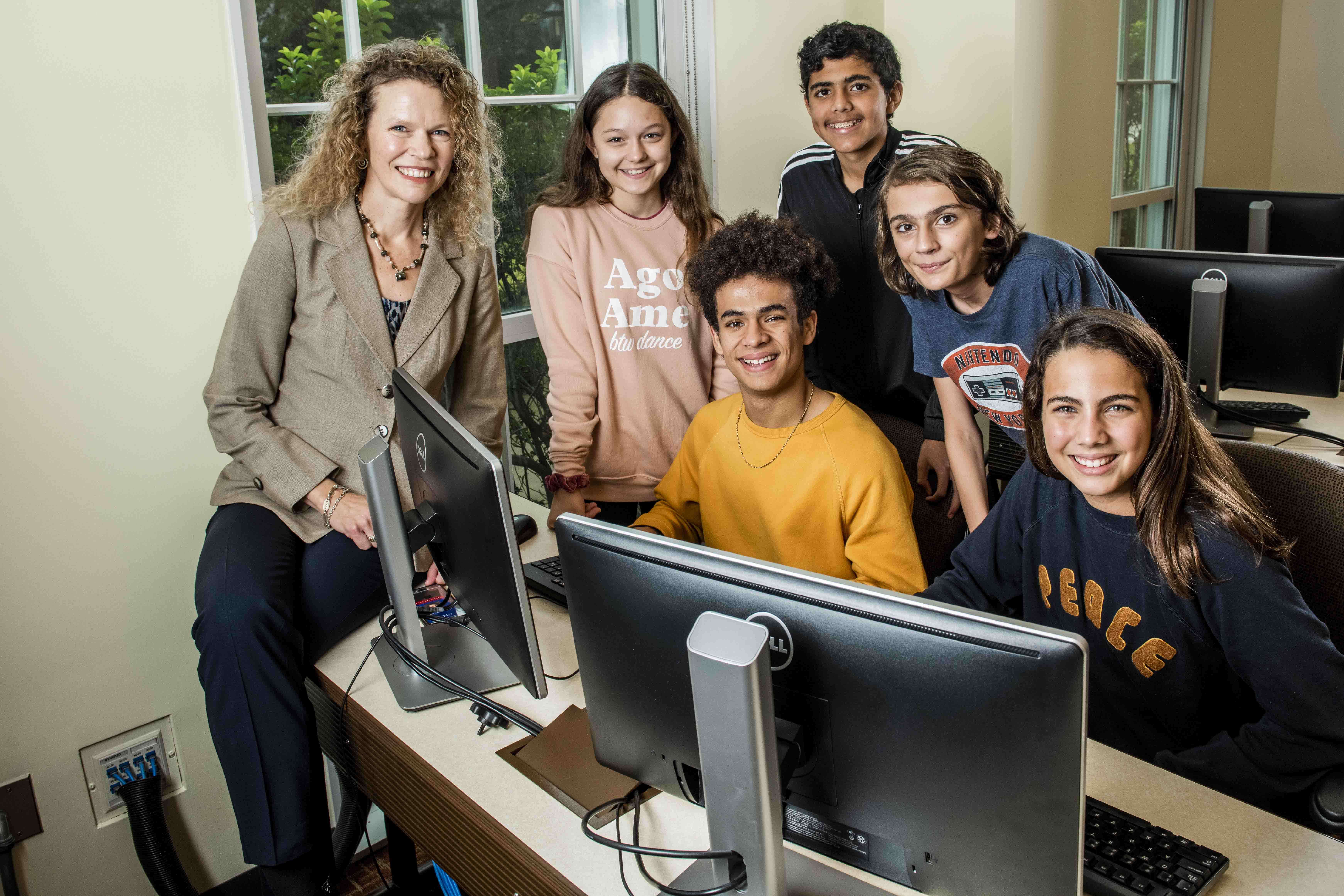 Dr. Leanne Ketterlin Geller working with students in a computer lab.