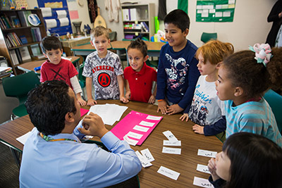 Young students listening to teacher in classwroom